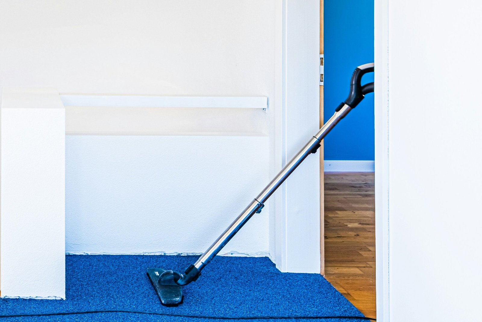 Eine Person überprüft einen geöffneten Staubsauger neben einer Bodendüse